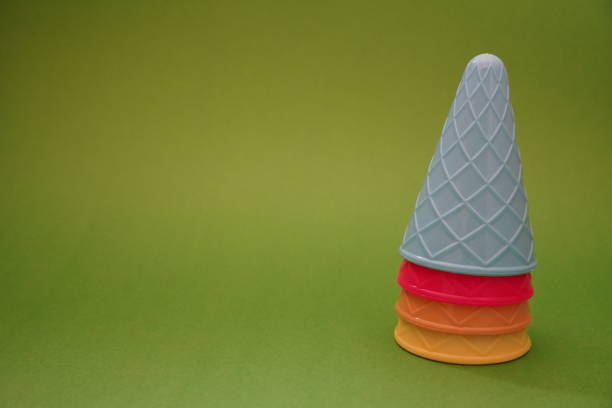 istock Colorful ice cream cone summer edition green background 1257356939