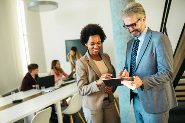 istock Two business person discussing inside modern office 1257356988