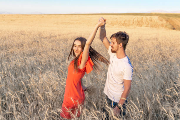 istock Young couple dancing in a wheat field 1257358394