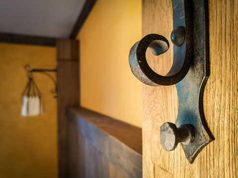 Wrought iron hook and wood panelling