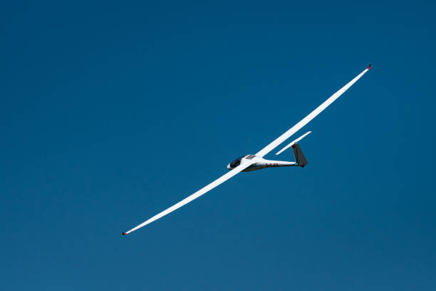 Mariazell, Austria - June 12, 2020: White sailplane from behind on a sunny day in summer, blue sky
