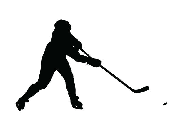 istock Ice hockey player vector silhouette. Hockey player shoots the puck on goal, isolated silhouette. Shooting hockey player 1257359562