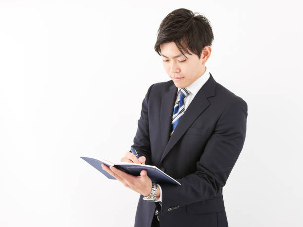 istock Japanese male businessman taking notes 1257359632