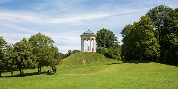 Munich, Bavaria / Germany - July 13, 2020: View on the so-called Monopteros at a sunny summer day. Located inside Englischer Garten, the largest park of Munich.