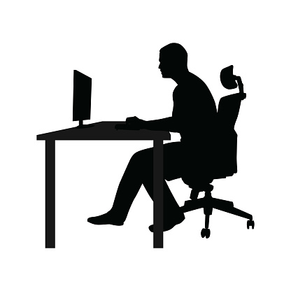 Man sitting on office chair at table and working on computer. Side view. Vector silhouette. Man working in office at desk and staring into monitor