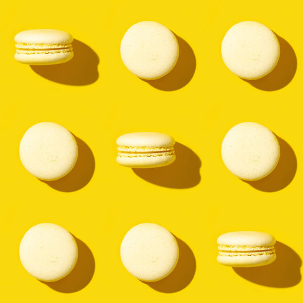 istock Seamless regular creative pattern of colorful french cookies macarons. Monochrome image.  Printing on fabric, wrapping paper. 1257360578