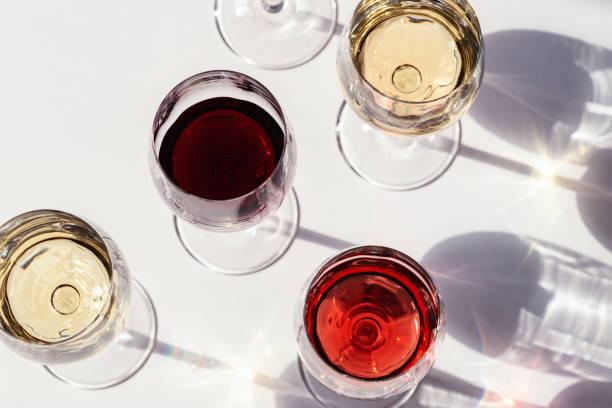 istock Red, rose and white wine top view in sunlight. Dark shadows 1257360646
