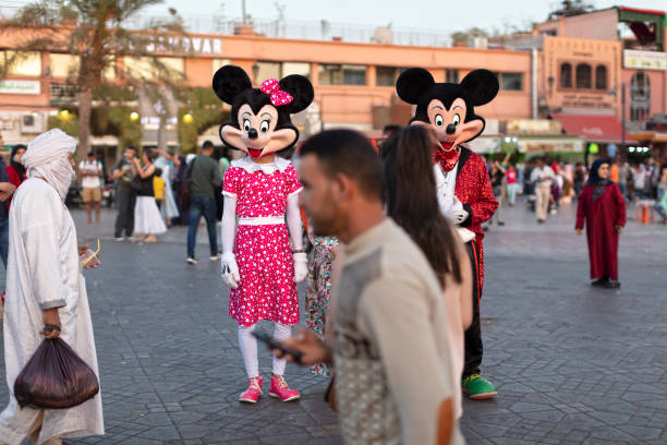 Marrakech, Morocco, June 26, 2019 : Disney Mickey Mouse Character in Costume Jemaa el-Fna Square at Night Marrakech City with Local and Foreign Tourist Groups