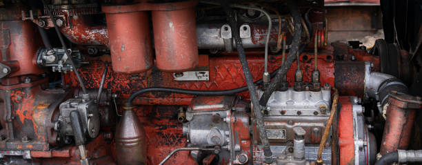 istock old diesel tractor engine close-up panorama, red and rusty 1257368119