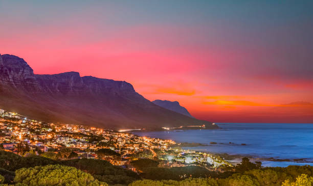 istock Camps bay illuminated at night with twilight sky 1257375714