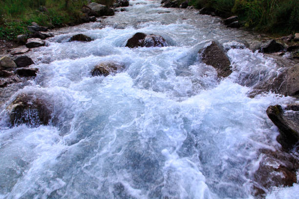 Mountain river among green mountains. Summer landscape. Kegeti Gorge, Kyrgyzstan.