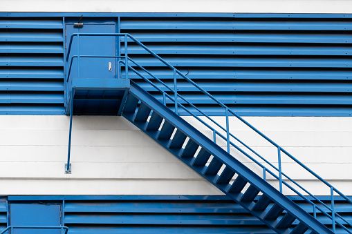blue steel stair outside of factory building for fire exit.