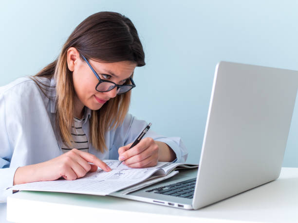 istock Distance learning online education. Woman studying with laptop, watching webinar 1257380508