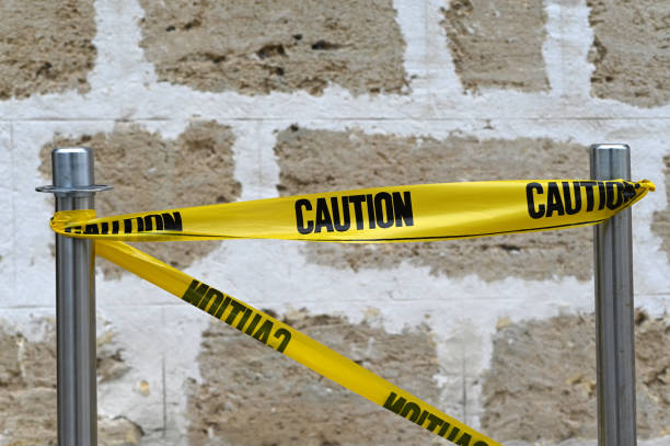 Yellow wall striped with black that can be used as background for making a composition about topics such as construction, danger or hazardous product.