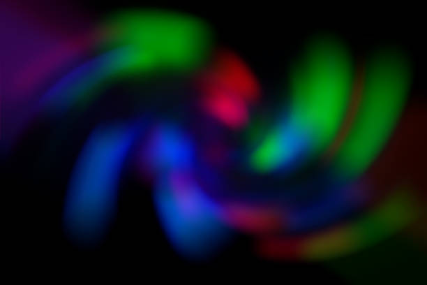 istock Blurred abstract gradient wave green, pink, blue, blurry Christmas and holiday lights background. Multicolored, bright spiral vortex in the dark 1257383109