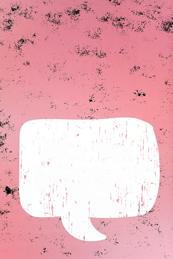 White speech bubble on pink color wooden background