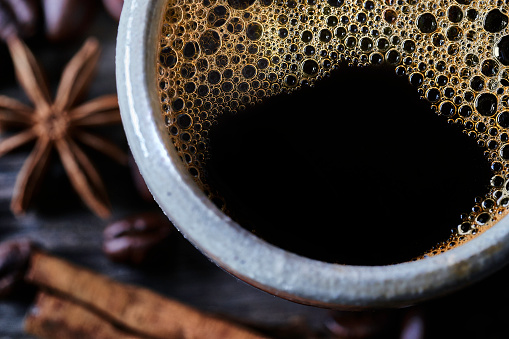 Close-up image of espresso coffee cup with foam and bubbles