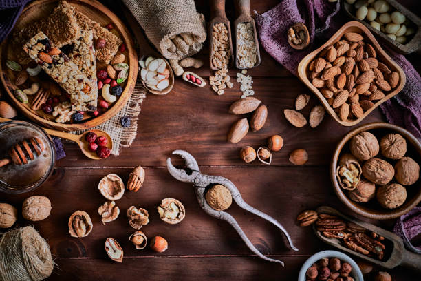 istock Variety of dried fruit and nuts on a table in a old fashioned rustic kitchen with nutcracker 1257384647