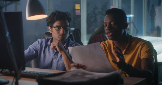 istock Designers discussing 3D modeling for video game 1257386135