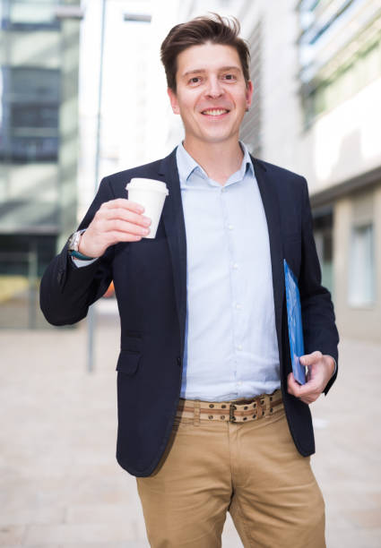 istock Professional man in jacket walking with coffee 1257388337
