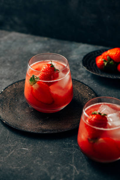 istock two strawberry cocktail with ice on dark background 1257388889