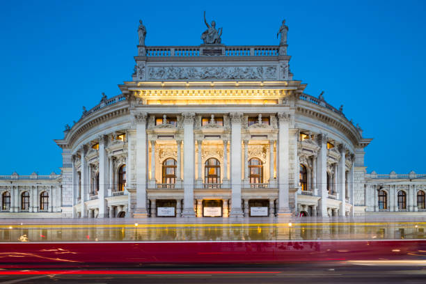 Burgtheater in Vienna, Austria at Night, editorial VIENNA - MAY 4: View of the Burgtheater in Vienna, Austria at night with a tram passing on May 4, 2018 burgtheater vienna stock pictures, royalty-free photos & images