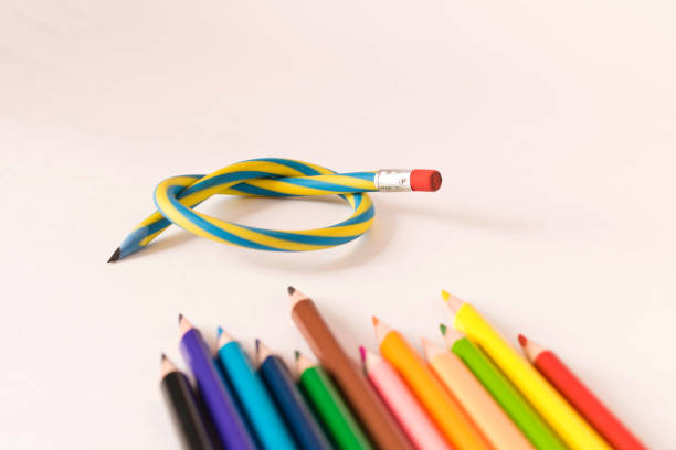 istock Flexible pencil and a set of colored pencils on a light background. Selective focus. 1257390919