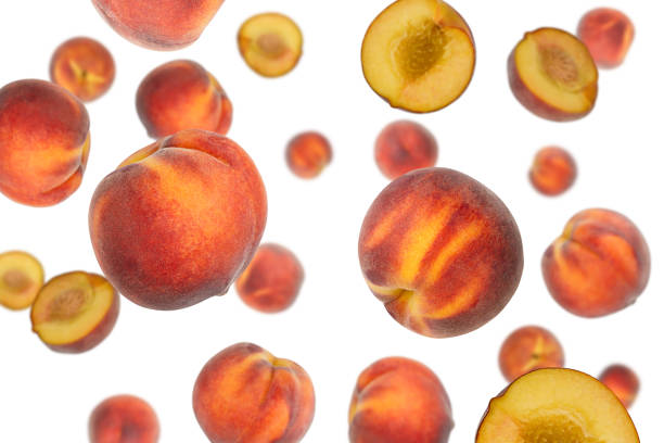 istock Falling peaches isolated on a white background with clipping path. Flying fruit 1257391735