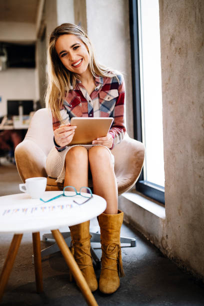 istock Portrait of a smiling designer, student, freelancer business woman using tablet computer 1257391769