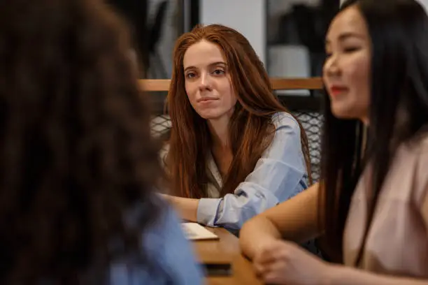 Selective focus of two office colleagues during a business discussion in the conference room.