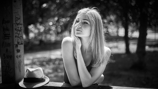 Carefree blond woman outdoors. Black and White.