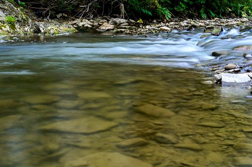 Mountain river with clean cold water and stones