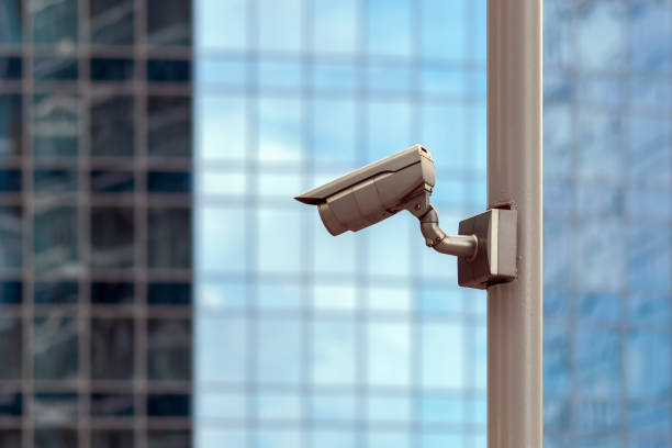 istock video surveillance camera against glass office facade background 1257394906
