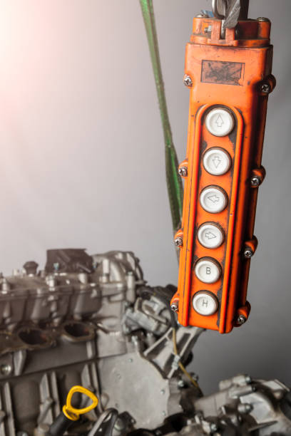 istock Orange control panel for a crane in an in-booster production or in a car service with buttons for moving in different directions of raising and lowering. 1257396473