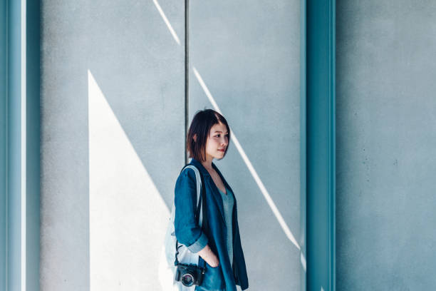 istock Young asian female architect with camera working in a construction site 1257396642