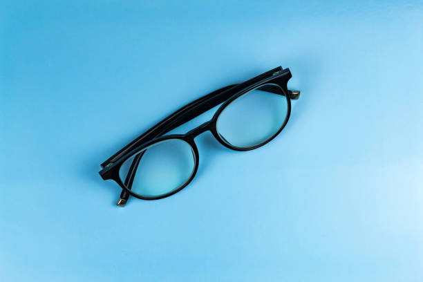 istock black folded glasses lie on a blue background 1257402972