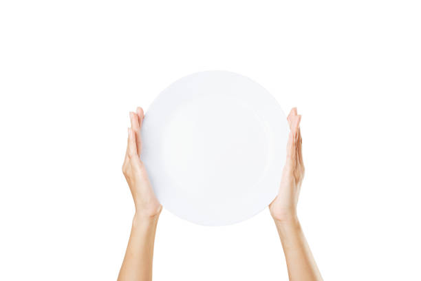 istock White plate on hand woman on white 1257404882