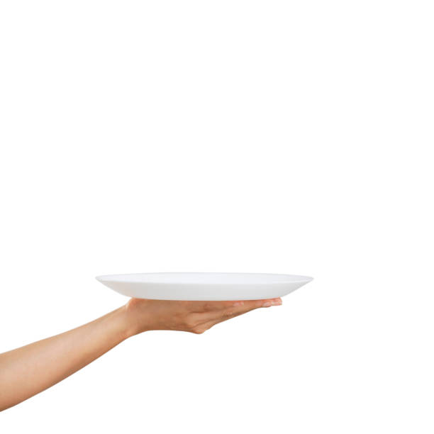 istock White plate on hand woman on white 1257404898