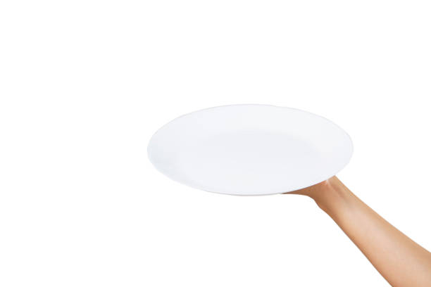 istock White plate on hand woman on white 1257404907