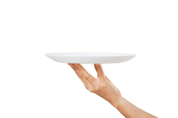 istock White plate on hand woman on white 1257404908