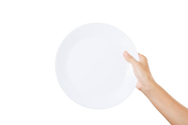 istock White plate on hand woman on white 1257404910