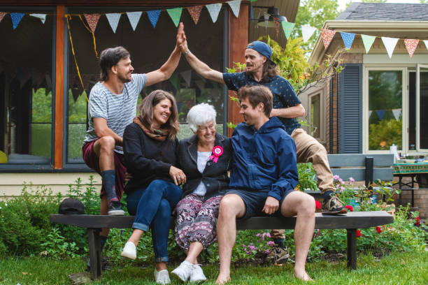 Senior people in the garden celebrating birthday Senior wowen, celebration her birthday, 85 years old , in front yard,  Quebec, Canadda happy birthday cousin images stock pictures, royalty-free photos & images