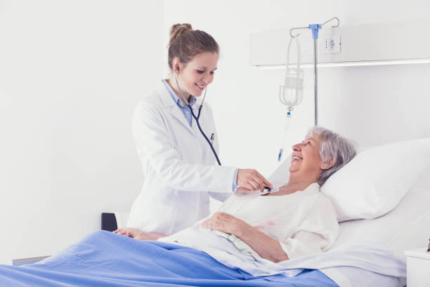 istock Smiling woman doctor examining an elderly lady 1257405064