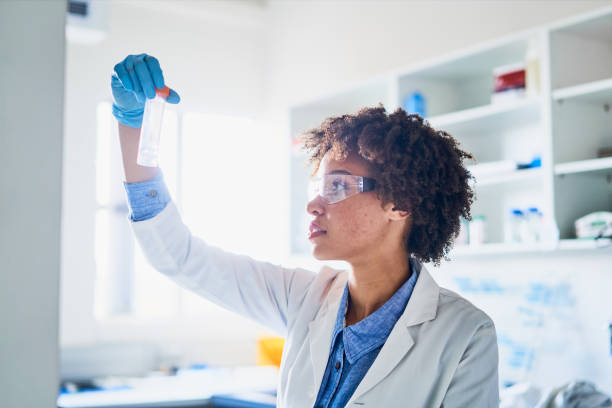 istock Young female scientist examining a research sample in a lab 1257407256