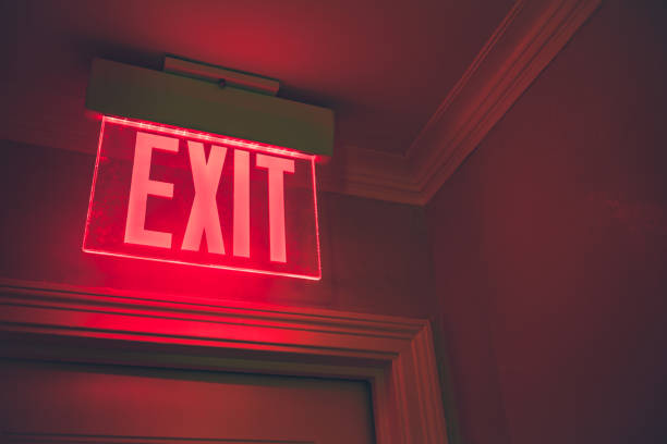 Exit sign in building with red background stock photo