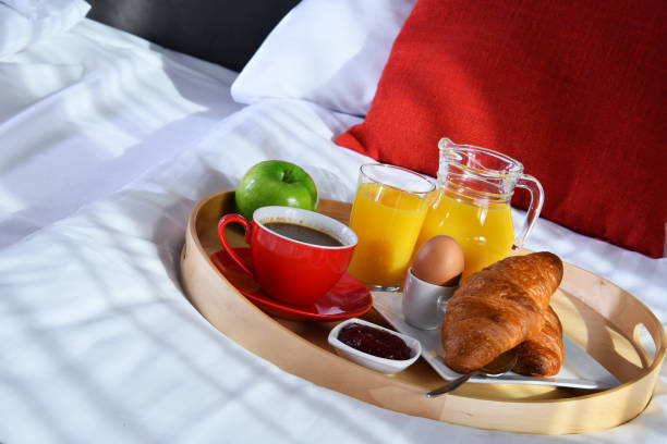 istock Breakfast on tray in bed in hotel room 1257410313