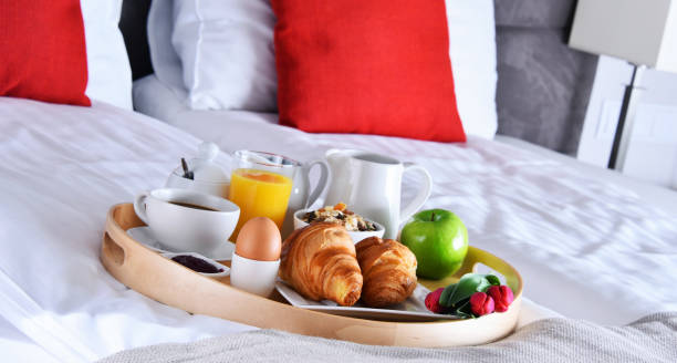 istock Breakfast on tray in bed in hotel room 1257410339