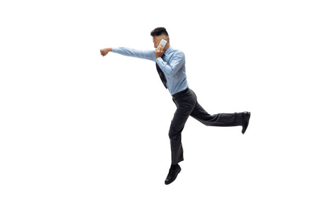istock Man in office clothes practicing taekwondo on white background. Unusual look for businessman in motion, action. Sport, healthy lifestyle. 1257411667