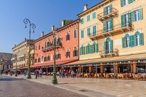 People strolling on the Liston in Piazza Bra, in the heart of the historic center of the city of Verona, one of the most important and visited cities in the Veneto region, in northeast Italy.