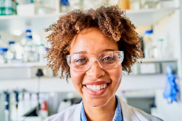istock Smiling young scientist wearing protective eyewear standing in a lab 1257412537